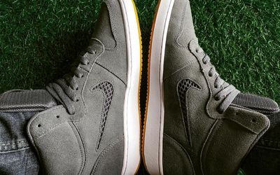 Close up of sports shoes stepping on a gray surface