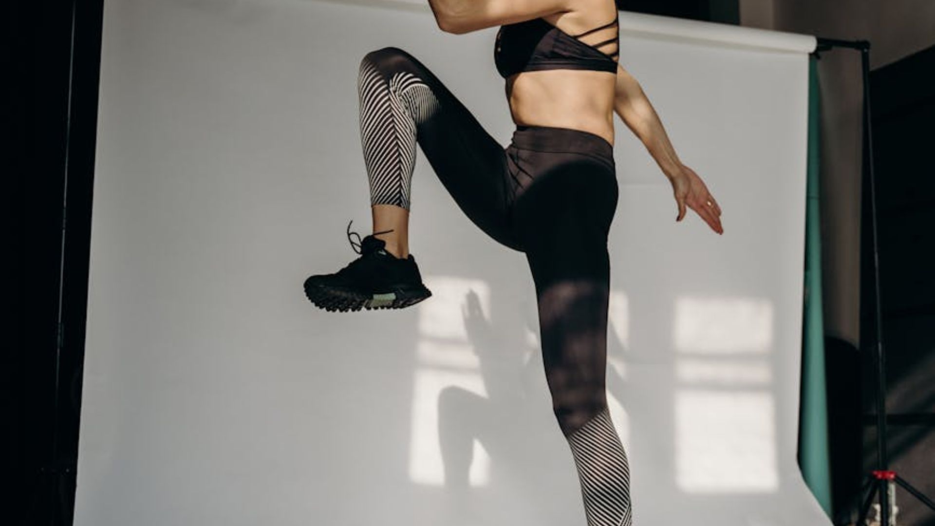 Person doing active cardio exercises in a bright minimalist studio